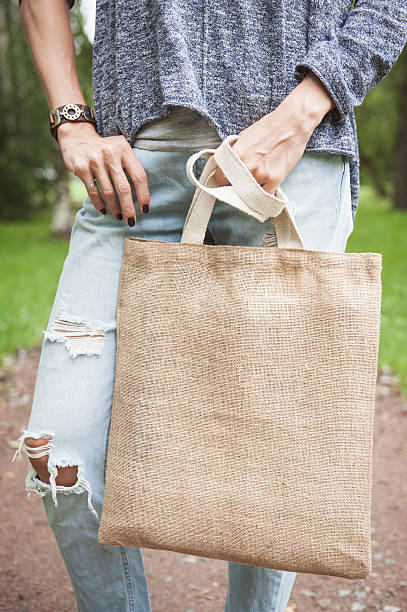 istock Woman holding empty canvas bag. Template mock up 609029968