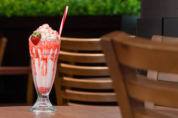 cold cocktail in a glass with a straw