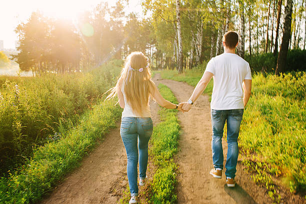 istock young couple walking happily by the forest 609031828