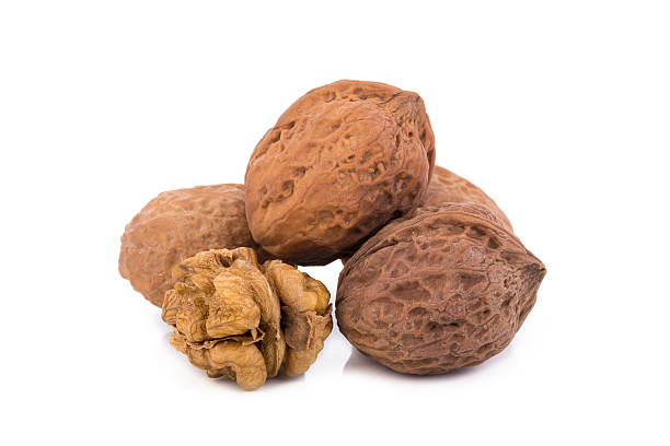 istock walnut and a cracked walnut isolated on the white background 609032120