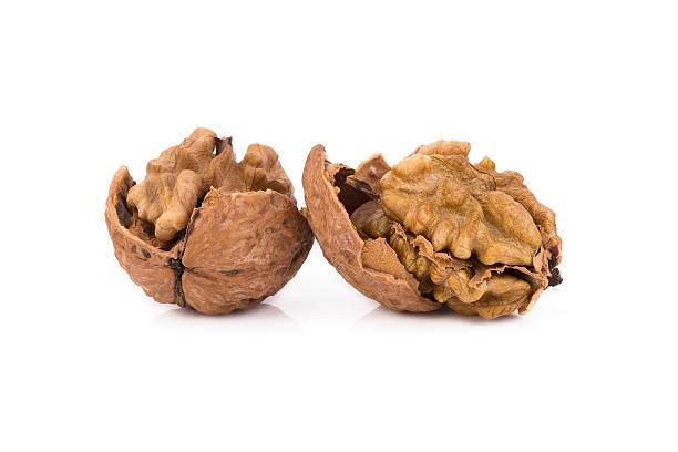 istock walnut and a cracked walnut isolated on the white background 609032408