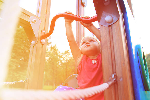 istock little girl playing on monkey bars, kids sport 609035546