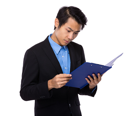 Businessman reading clipboard