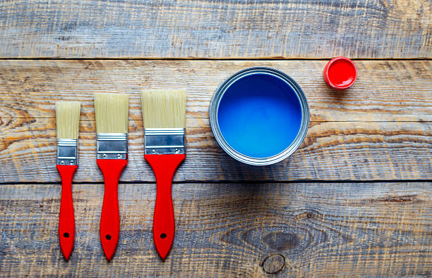 istock painting with can blue paint on wooden background 609035784