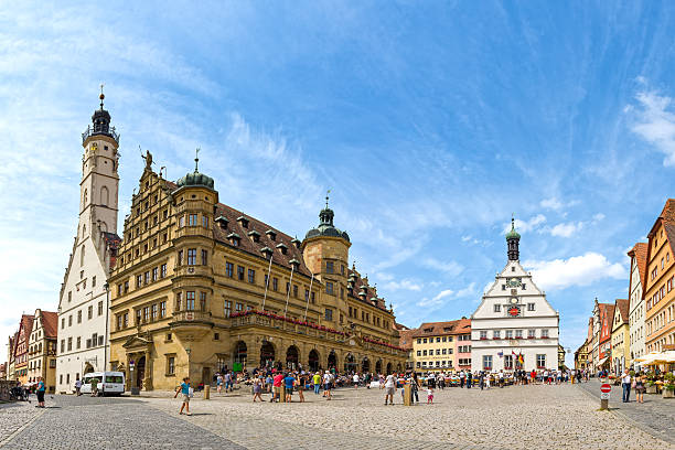 Rothenburg Ob Der Tauber, Germany - July 11, 2016: Market Place of the historic old town Rothenburg ob der Tauber with Rathaus buildings in summer.  Rothenburg ob der Tauber is a famous town in Bavaria, west of Munich, Germany. This old bavarian city is situated on the Romantic Road. Rothenburg ob der Tauber is a UNESCO World Heritage site.