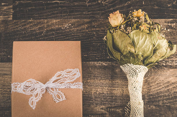 istock Lovely brown gift with a beautiful white ribbon on table 609038042