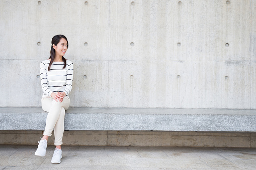 beauty woman smile and sit with white wall, asian