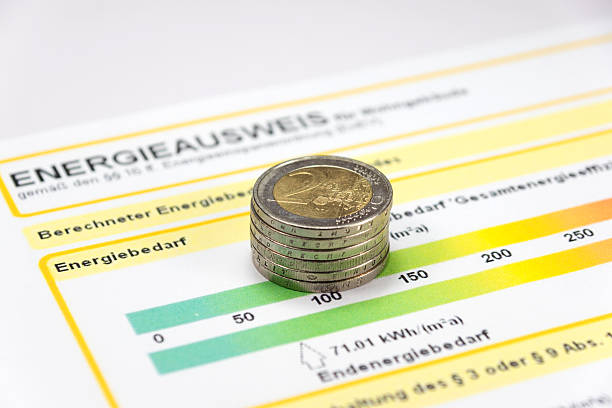 An energy certificate and money An energy performance certificate and euro coins energieausweis stock pictures, royalty-free photos & images