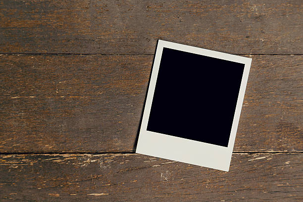 istock Vintage photo frame blank on old wood background with space 609042482