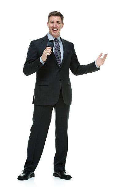 istock Cheerful businessman presenting with microphone 609042774