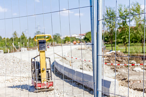 istock View trough mobile light metal fence on vibration plate compacto 609044454