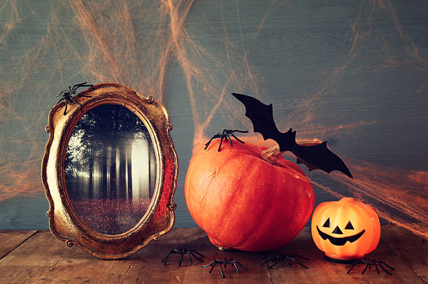 istock Halloween holiday concept. Cute pumpkin, bats and old frame 609047228