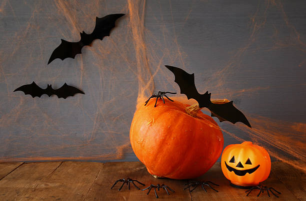 istock Halloween holiday concept. Cute pumpkin and bats 609047326
