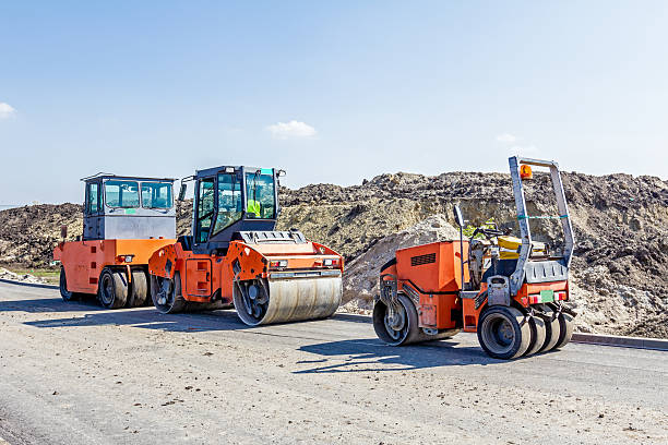istock Steamrollers are parked at building site. Machinery for road con 609047480
