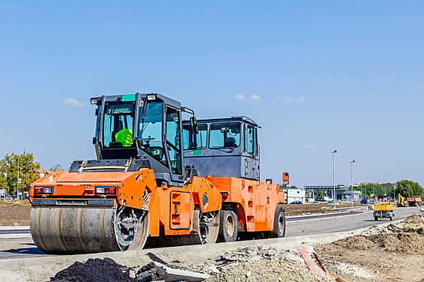 istock Steamrollers are parked at building site. Machinery for road con 609047780