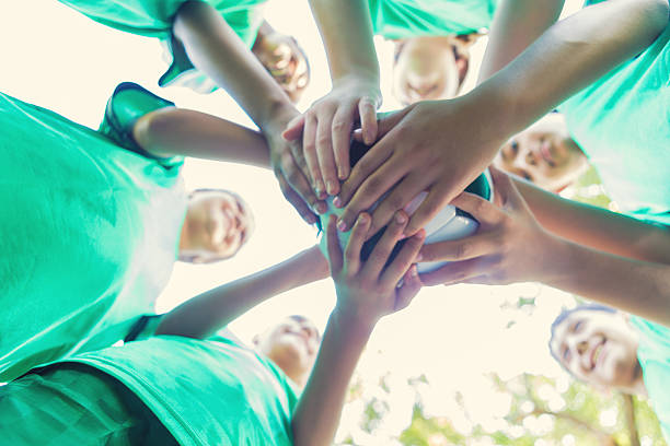 istock Diverse friends on soccer team huddling together before game 609049204