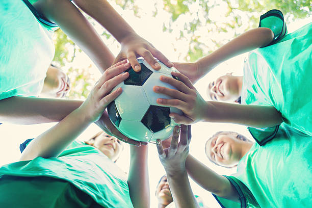 istock Diverse teammates huddle together to cheer before soccer game 609049354