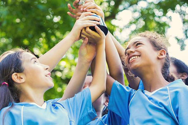 istock Diverse female soccer team holding up a trophy 609049428