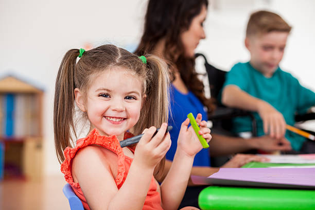 istock Excited preschool girl in class 609050256
