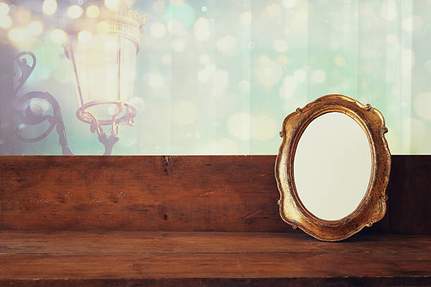 istock Golden old blank frame on wooden window sill 609051976
