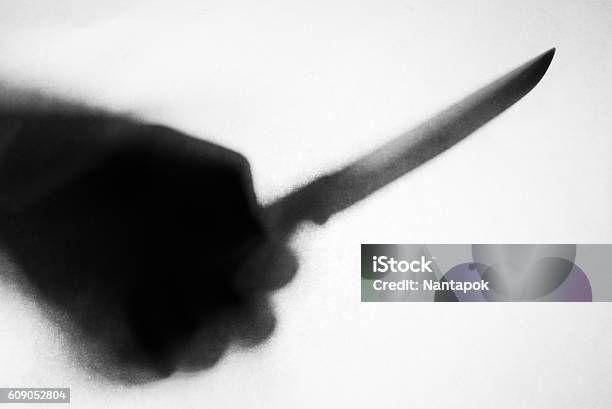 Shadow Of Hand Holding Knife Stabbing Someone Stock Photo - Download Image Now - Kitchen Knife, Knife - Weapon, In Silhouette