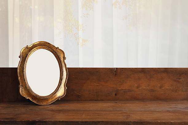 istock Golden old blank frame on wooden window sill 609053692