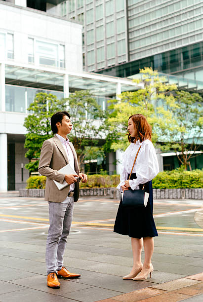 istock Two Japanese business people in financial district 609055172