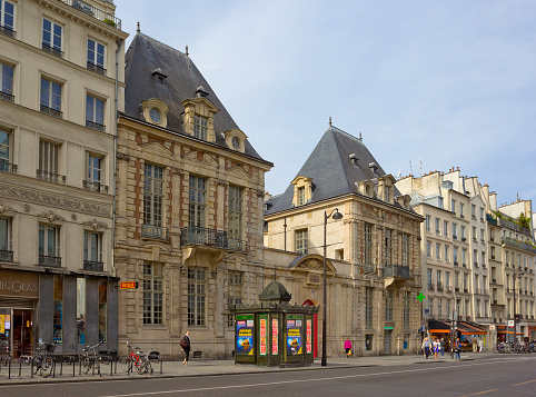 Paris, France - July 31, 2015: Rue Saint-Antoine with old historical buildings and walking people