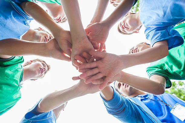 istock Circle of soccer players with hands together before game 609056704