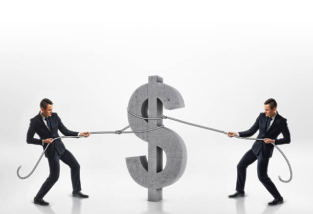 istock Two businessmen pulling big concrete 3d dollar sign with ropes 609056806