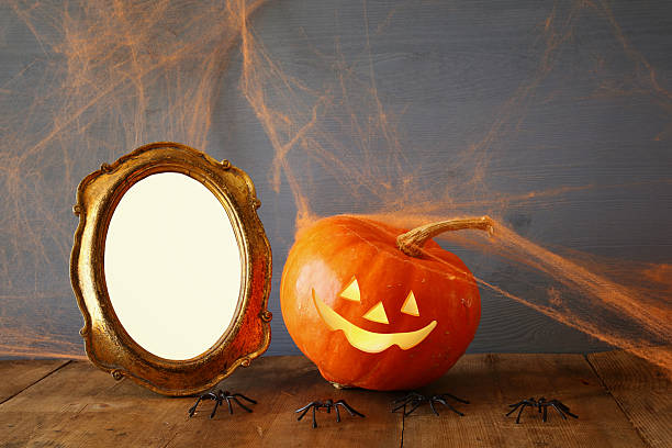 istock pumpkin next to blank photo frame on wooden table 609057396