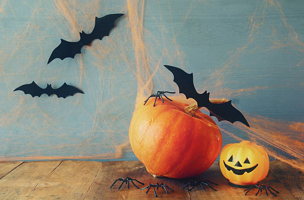 istock Halloween holiday concept. Cute pumpkins and bats 609057582