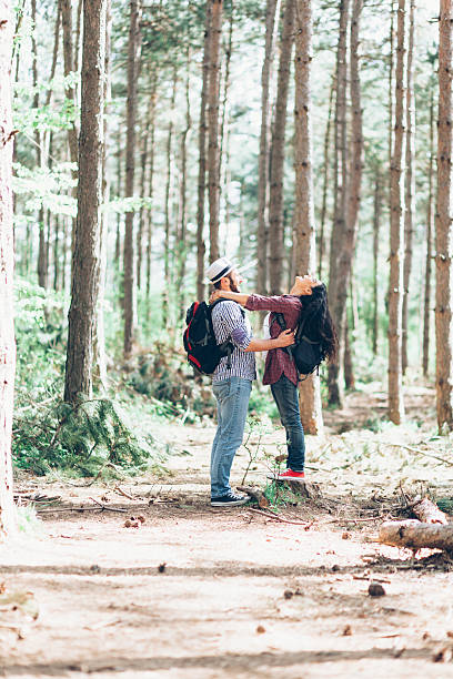istock Cheerful young couple in love having fun in the forest 609057706
