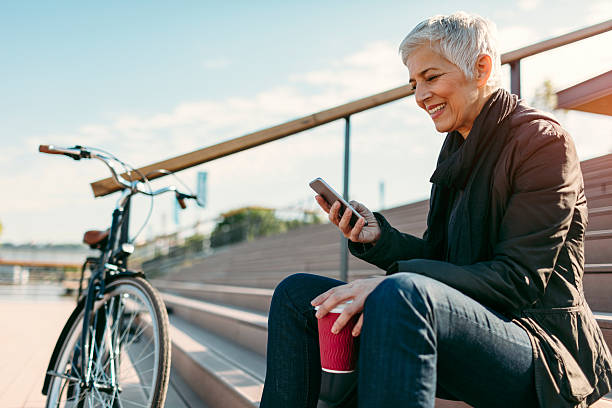 istock Smiling Mature Woman Using Smart Phone. 609059566