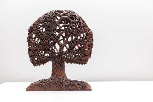 wooden sculpture of tree on white background