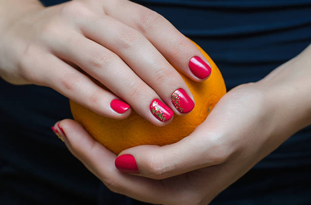 istock Female hands with pink nail design. 609060596