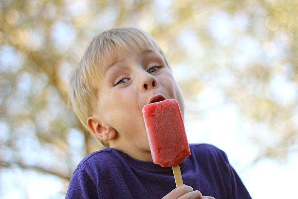 istock Young Child Eating Frozen Popsicle Outside 609060632
