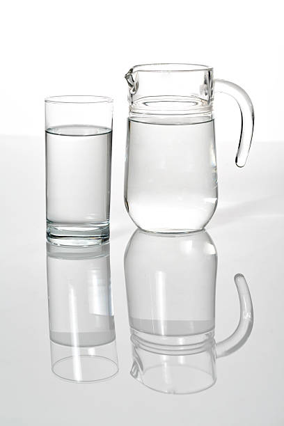 istock Drinking glass and Jar with pure water 609061294