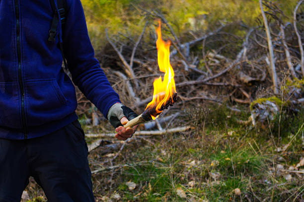 istock part of a man and hand with torch  flame in 609065090