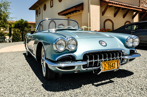 Livermore, California, United States - July 8, 2014: A beautifully restored  1958 Corvette painted in the original GM colors displayed in front of the tasting room  of the Ruby Hills WInery in Livermore, CA