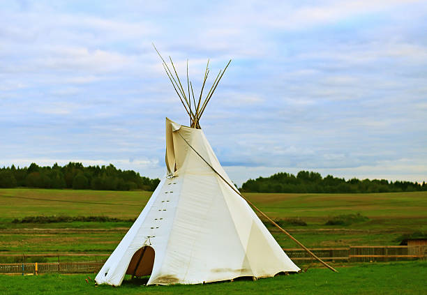 istock White wigwam on green field 609072228
