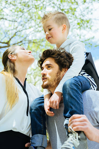 istock Mother Kissing Goodbye Husband And Son Before Going To Work 609072396