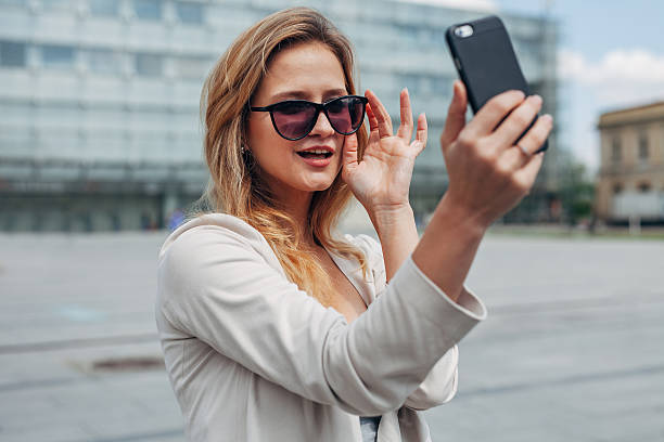 istock Girl taking selfie. Urban background. 609074080