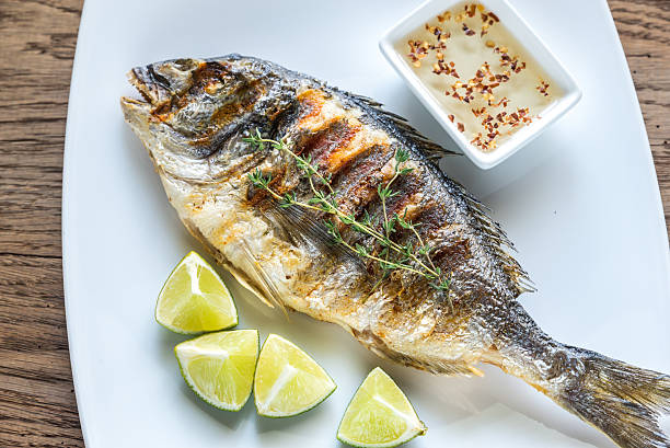 istock Grilled Dorade Royale Fish on the plate 609074484