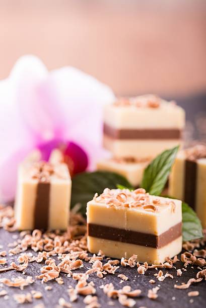 istock Several two-colored nougat cubes on slate stone with orchid 609075916