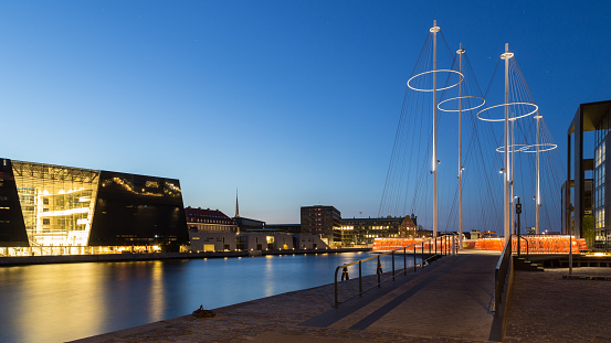 Panoramic nightshot of the modern Circle Bridge and the Royal Library in Copenhagen, Denmark