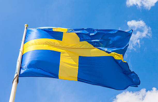 istock Swedish flag with yellow cross waving in the wind 609078038