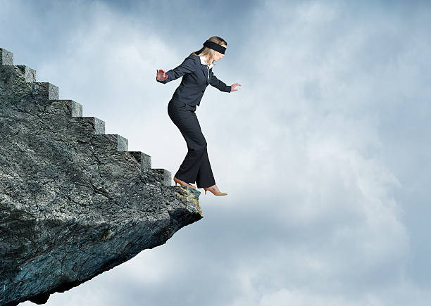 istock Blindfolded Businesswoman About To Step Off Stairs 609079150