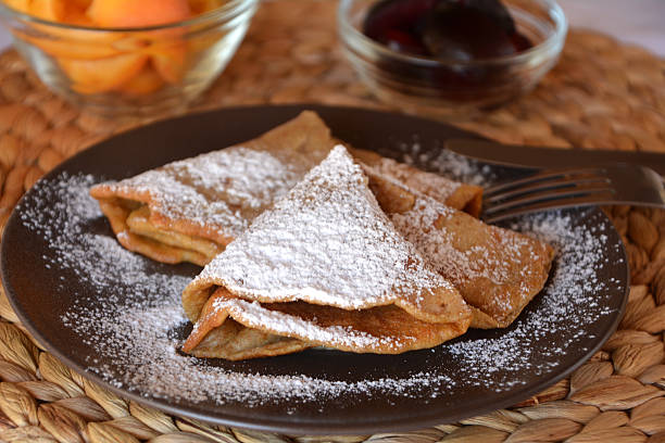 istock Homemade pancakes with jam, apricots and icing sugar. 609079652