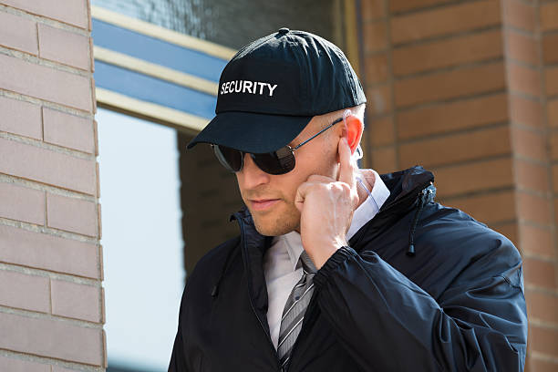 istock Young Security Guard Standing In Front Of The Entrance 609080180